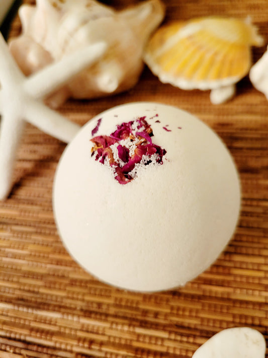 White round bath bomb with rose petals on top
